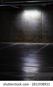 Empty Parking Lot With Overhead Dim Light, Underground Parking Garage.