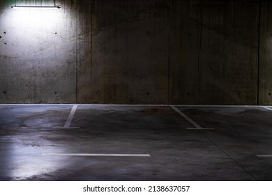 Empty Parking Lot With Overhead Dim Light, Underground Parking Garage.