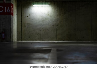 Empty Parking Lot With Overhead Dim Light, Underground Parking Garage.