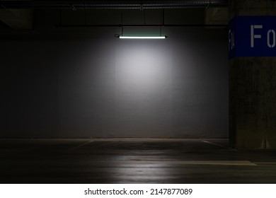 Empty Parking Lot With Overhead Dim Light, Underground Parking Garage.