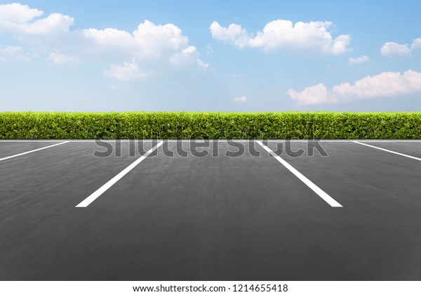 Empty\
parking lot In the park with blue sky\
background
