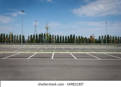 Empty parking lot with trees in the distance - Shutterstock ID 149821307