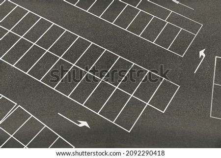 An empty parking lot with white lines on it.