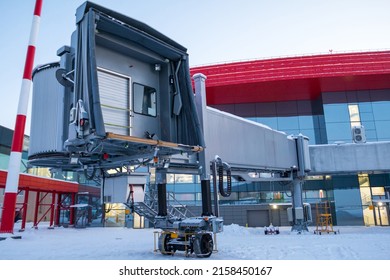 Empty Passenger Air Bridge At Winter Airport Apron