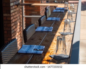 An Empty Patio Dining Area With Place Settings.