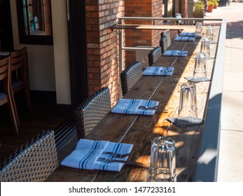 An Empty Patio Dining Area With Place Settings.