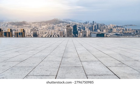 Empty Paved Platform Overlooking Urban Skyline And Distant Mountains