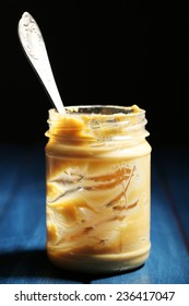 Empty Peanut Butter Jar On Table, On Dark Background