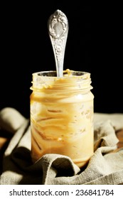 Empty Peanut Butter Jar On Table, On Dark Background