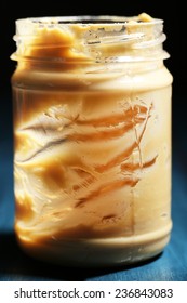 Empty Peanut Butter Jar On Table, On Dark Background