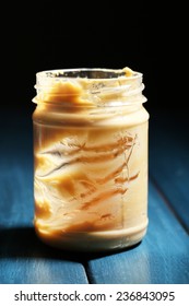 Empty Peanut Butter Jar On Table, On Dark Background