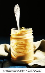 Empty Peanut Butter Jar On Table, On Dark Background