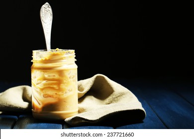 Empty Peanut Butter Jar On Table, On Dark Background