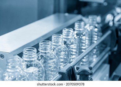 The Empty PET Bottles  On The Conveyor Belt For Filling Process In The Drinking Water Factory. The Hi-technology Of Plastic Bottle Manufacturing Process.