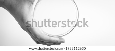 Empty petri dish for growing cultures of microorganisms in doctor hand , fungi and microbes. A Petri dish  ( Petrie dish. Petri plate or cell-culture dish)