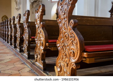 Empty Pews Inside Church Close-up, Carved Wooden Pews In Catholic Cathedral, Detail Of Christian Church Interior. Beautiful Old Pews, Worship Benches In Sanctuary. Prayer, Faith And Service Concept.