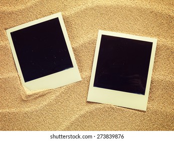 Empty photo cards in retro style  lying on a sea sand. Sunny summer background. Space for your text. - Shutterstock ID 273839876