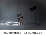 Empty photo studio with lighting equipment. Space for text. Vacant directors chair. The concept of selection and casting. Job recruitment advertisement.