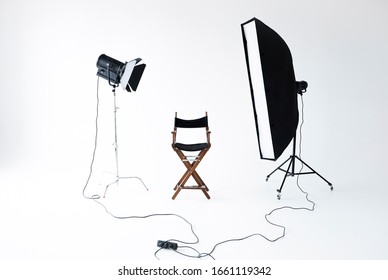 Empty Photo Studio With Lighting Equipment. Space For Text. Vacant Directors Chair. The Concept Of Selection And Casting. Screensaver For Your Desktop. Job Recruitment Advertisement.