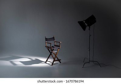 Empty photo studio with lighting equipment. Space for text. Vacant directors chair. The concept of selection and casting. Job recruitment advertisement. - Shutterstock ID 1670786194