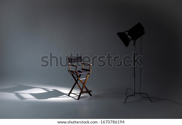 Empty photo studio with\
lighting equipment. Space for text. Vacant directors chair. The\
concept of selection and casting. Job recruitment\
advertisement.