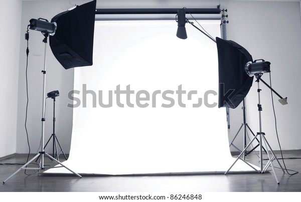 Empty photo studio\
with  lighting equipment