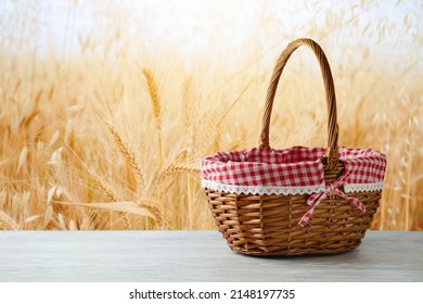 Empty picnic basket on wooden white table over wheat field blurred background. Shavuot holiday mock up for design and product display - Shutterstock ID 2148197735
