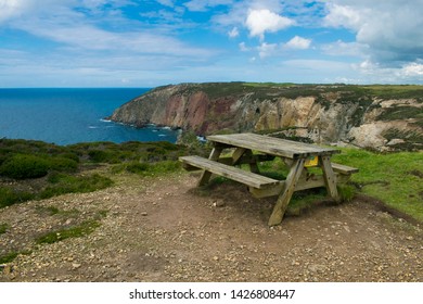An empty picnic bench overlooking the Cornish coastline at Perranporth,UK. 