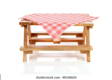 Empty Picnic Table With Tablecloth Over White Background