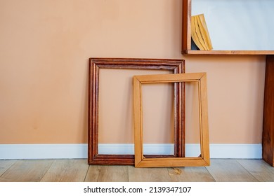 empty picture frames against the wall. baguette workshop. materials and accessories for creativity and drawing.
