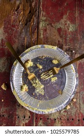 Empty Pie Tin With Two Forks On Rustic Wood Table Top View