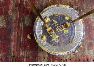 Empty Pie Tin With Two Forks On Rustic Wood Table Top View