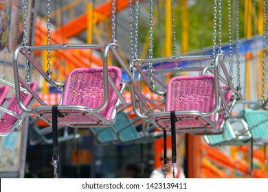 Empty Pink Chair Of Chair Swing Ride At Amusement Park