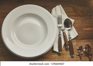 Empty Place Setting With Rosary And Copy Space On Wooden Background