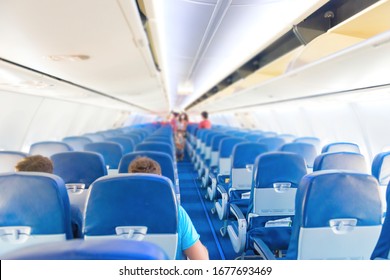 Empty Plane Interior With Few People And Stewardess During Coronavirus Pandemia