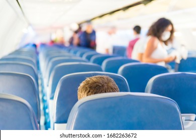 Empty Plane Interior With Few People And Stewardess During Coronavirus Pandemia