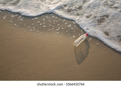 Empty Plastic Bottle On Sea Beach, Environmental Or Polution Concept