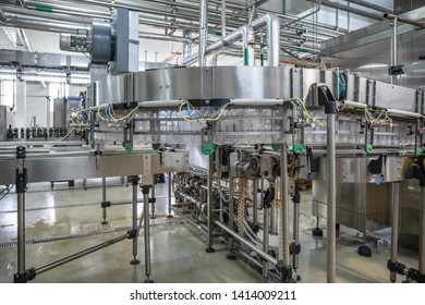 Empty Plastic Bottles Move On Automatic Conveyor Line Or Belt In Water And Juice Factory Or Plant Production.