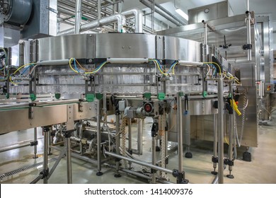 Empty Plastic Bottles Move On Automatic Conveyor Line Or Belt In Water And Juice Factory Or Plant Production.