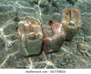 Empty Plastic Cans Under Water. Sea Pollution. Old Plastic Containers On The Bottom Of The Sea.
