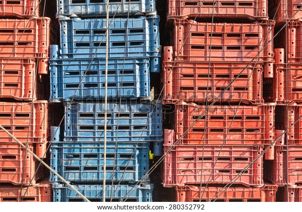 Empty plastic\
cargo boxes are stacked in a\
truck