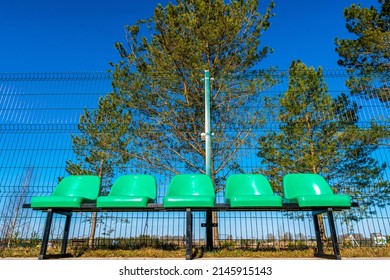 Empty Plastic Chairs In The Outdoor Basketball Court From A Low Angle