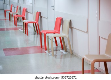 Empty plastic chairs waiting for the patients in the corridor Dental Clinic