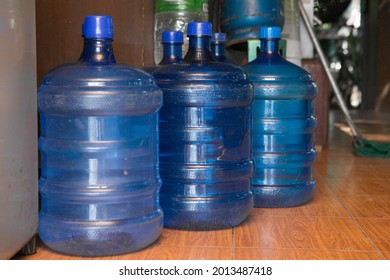 Empty plastic drinking water tanks on the floor