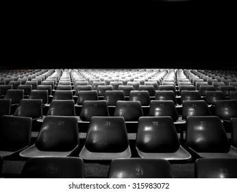 Empty plastic seats at stadium with black and white color - Shutterstock ID 315983072