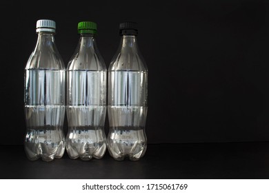 Empty Plastic Soft Drink Bottles On A Black Background