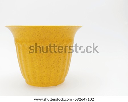 Empty plastic yellow plant pot with dotted and stripped isolated on white background