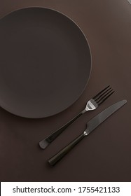 Empty Plate And Cutlery As Mockup Set On Dark Brown Background, Top Tableware For Chef Table Decor And Menu Branding Design