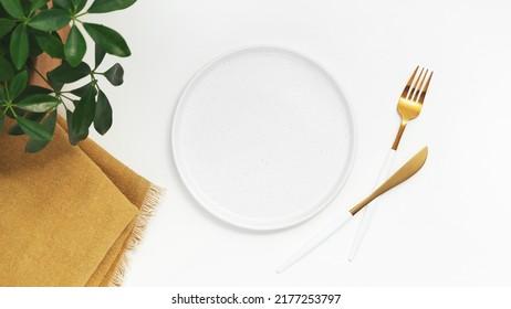 Empty plate with fork and knife on white background. Top view. High quality photo