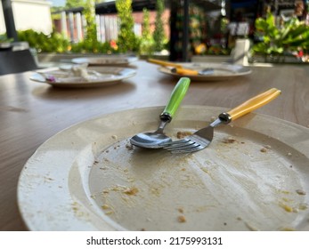 An empty plate with fork and spoon.